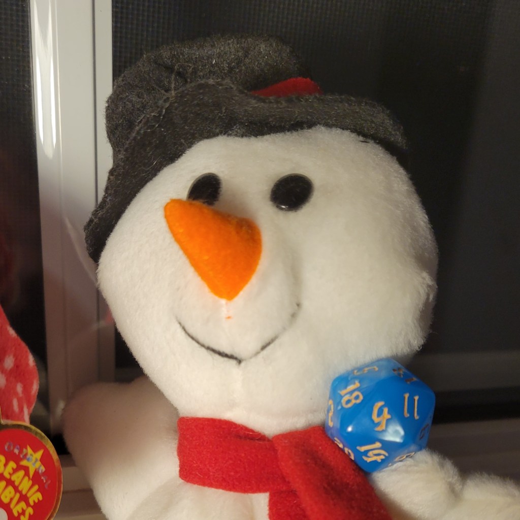 A smiling snowman beanie baby holds an icy-blue 20-sided die in a hand against a dark window.