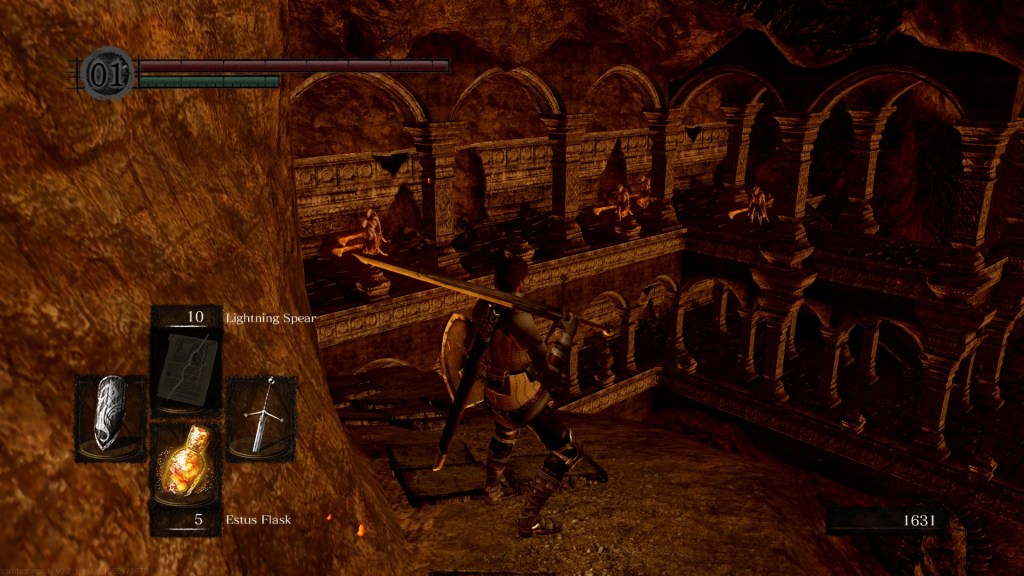 A brown haired figure stands on a cliff edge, overlooking an infernal cavern. On opposing wall is a series of arches, through which lines of demons are visible.