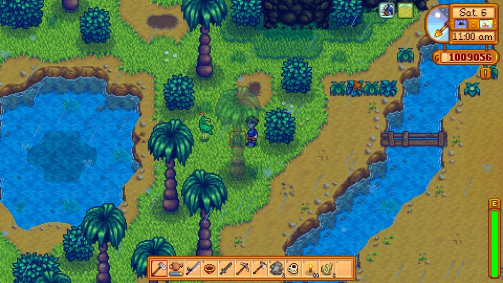 Screenshot from Stardew Valley. Farmer stands in the rain on the tropical Cinder Island, staring at an emerald green flamingo next to a pond.